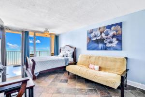 a living room with a couch and a bed at Atlantic Skies in Daytona Beach Shores