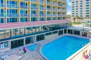 an overhead view of a swimming pool in front of a hotel at Atlantic Skies in Daytona Beach Shores