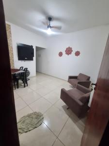 a living room with a couch and a flat screen tv at Casa Atenas 2 in Três Lagoas
