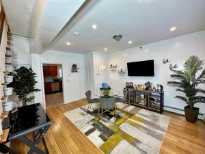 a living room with a table and a tv on a wall at BP STAYS - Hotel-Style, No Host, Professionally Managed ID260 in Jersey City