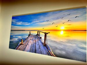 a painting of a pier on the water with birds at BP STAYS - Hotel-Style, No Host, Professionally Managed ID260 in Jersey City