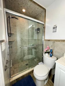 a bathroom with a toilet and a glass shower at BP STAYS - Hotel-Style, No Host, Professionally Managed ID260 in Jersey City +47 photos