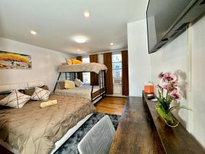 a bedroom with two bunk beds and a table at BP STAYS - Hotel-Style, No Host, Professionally Managed ID260 in Jersey City