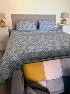 a bedroom with a bed with a colorful bedspread at Basement studio apartment in Ballina