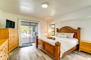 a bedroom with a bed with a cat laying on it at 4 Mi to Port C Beach Park! Classy Canal-Front Home in Port Charlotte +20 photos