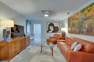 a living room with a couch and a table at Walk to Redington Beach Renovated Duplex with Patio in St Pete Beach