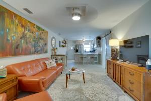 a living room with a couch and a table at Walk to Redington Beach Renovated Duplex with Patio in St Pete Beach +23 photos