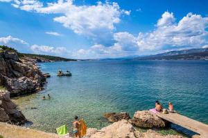a group of people in the water at a beach at Apartments in Silo - Insel Krk 13592 in Šilo +4 photos