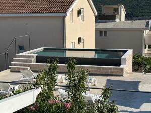 a swimming pool on the side of a building at B&B Guest House Vasiljevic in Herceg-Novi