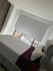 Ένα ή περισσότερα κρεβάτια σε δωμάτιο στο Encanto Del Parque