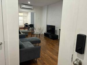 a living room with two couches and a tv at Spacious apartment in dowtown Montreal in Montréal +37 photos