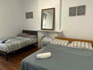 a bedroom with two beds and a mirror on the wall at Spacious apartment in dowtown Montreal in Montréal