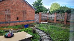 a garden in front of a brick building at Detached house for family in Hillsborough