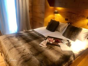 a bed with a blanket and a tray on it at Leonville Luxury Apartment in Roccaraso