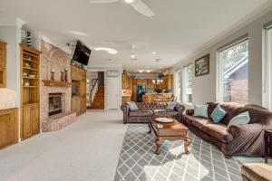 a living room with couches and a fireplace at Luxe Lakefront Home with Hot Tub, Dock and Fire Pit in Granbury