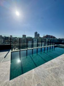 a swimming pool on the roof of a building at Foster Studio - Park in Buenos Aires