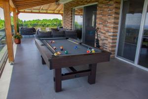 a pool table with balls on it on a patio at Holiday House Ad Astra in Čučerje