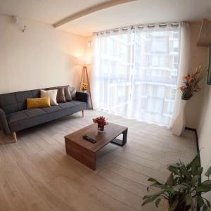 a living room with a couch and a coffee table at Exclusivo departamento en Barranco in Lima