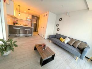 a living room with a couch and a coffee table at Exclusivo departamento en Barranco in Lima