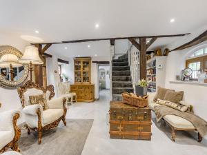a living room with furniture and a staircase at Ladymoor in Highley