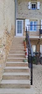 a staircase leading up to a building with a door at La Belle Bourguignonne in Crêches-sur-Saône