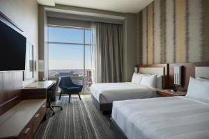 a hotel room with two beds and a large window at Kansas City Marriott Downtown in Kansas City