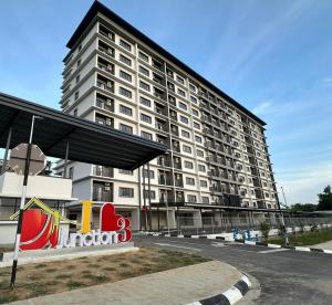 a large white building with a sign in front of it at Jenz-2 Homestay in Bintulu