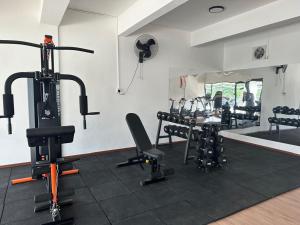 a room with a gym with bikes and a table at Jenz-2 Homestay in Bintulu