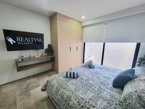 a bedroom with a bed with a sign on the wall at Live Playa Beach, Luxury & 5th Av at your doorstep in Playa del Carmen +40 photos