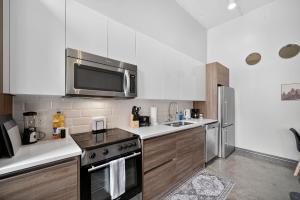 una cocina con estufa y microondas en Stunning Downtown Apartment with Pool, Laundry, Parking, en Dallas