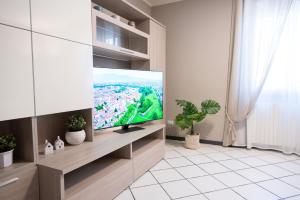 a living room with a flat screen tv on a wall at La casa di Emilia in Lucca
