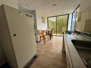 a kitchen and dining room with a table and chairs at Apartamento campestre in Sasaima