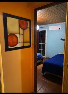 a room with a bedroom with a bed and a window at La casita in Puerto Iguazú