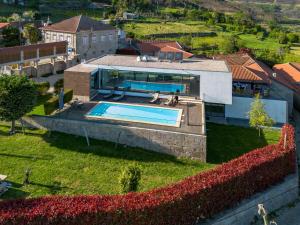 an aerial view of a house with a swimming pool at Casa do Barroso - Casa Mãe in Cabeceiras de Basto