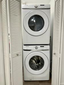 a washing machine and a dryer in a closet at Designer 1 Bedroom Condo in Silver Lake in Los Angeles