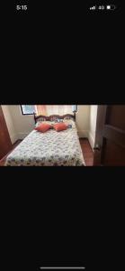 a bedroom with a bed with two pillows on it at Habitaciones económicas in Cuenca