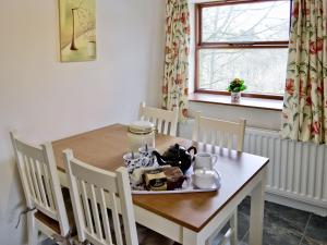 a dining room table with a plate of food on it at Greystones Cottage in Hardraw