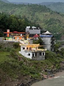 a group of buildings on a hill near the water at Escaven - Your escape to Heaven 