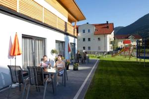two women sitting at a table on a patio at Apartments in Flachau - Salzburger Land 368 in Flachau