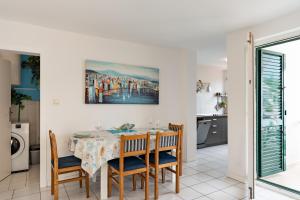 a dining room with a table and chairs at Apartments with parking space Vidalici, Pag - 9393 in Kustići