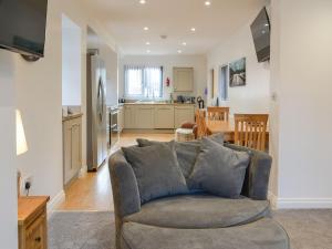 a living room with a couch and a kitchen at Trinity Avenue Cottage in Bridlington
