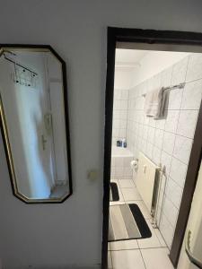 a bathroom with a mirror and a shower in it at Panorama building in Eschborn +19 photos