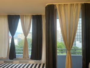 a bedroom with a large window with curtains at Panorama building in Eschborn