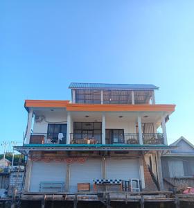 a building with balconies on the side of it at Jojo Komodo Homestay in Komodo
