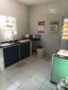 a kitchen with a sink and a toilet at Chácara Duquinha 
