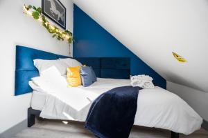 a blue and white bedroom with a white bed at The Cosy Place - BHX Airport, NEC, HS2 & RES World in Marston Green