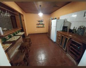 a kitchen with a refrigerator and a table and chairs at La casita in Puerto Iguazú