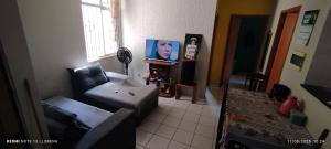 a living room with a couch and a chair at Lorena in Ananindeua