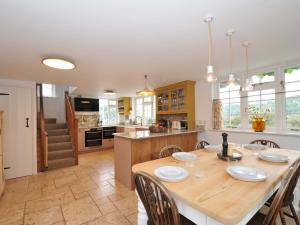 a large kitchen with a wooden table and chairs at Island House in Fowey
