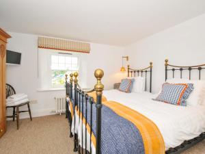 a bedroom with two beds and a window at Island House in Fowey